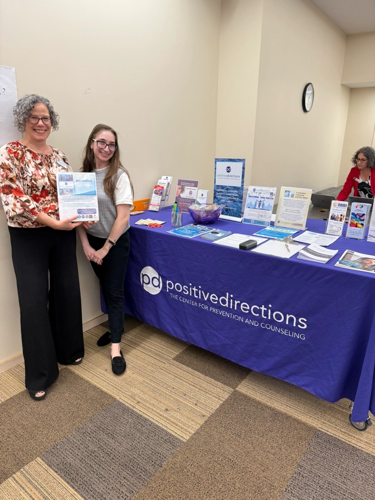 Positive Directions staff at a community outreach table