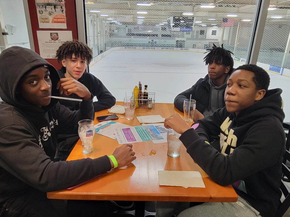 Teens ice skating at a Positive Directions teen night out